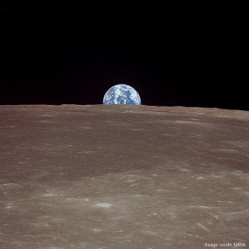 You will see the Earth rise above the Moon's surface.